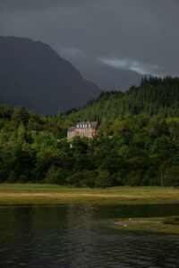 Country house hotel set among woodland beside a loch in the Scottish Highlands